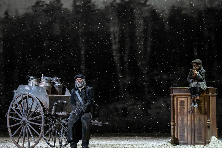 It's snowing. Tevye has his cart and The Fiddler is sitting on a cupboard. 